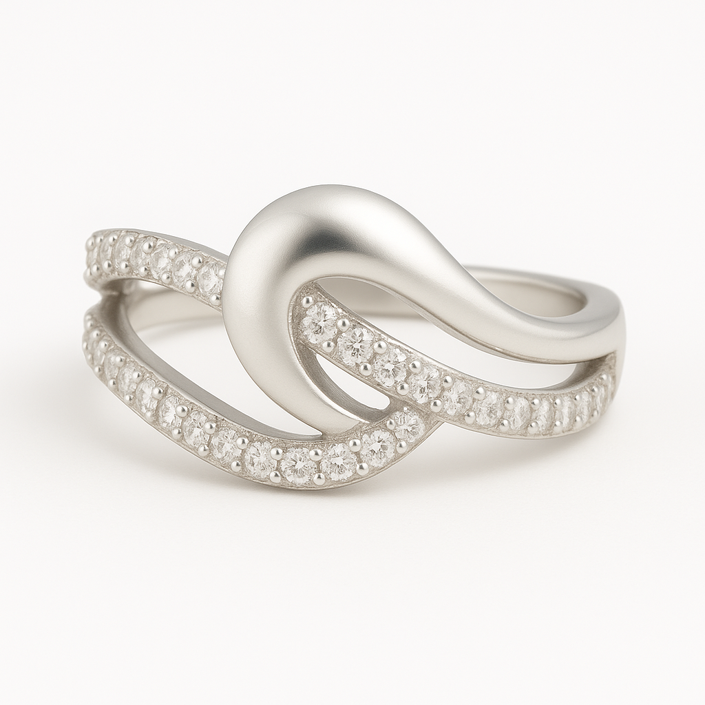 Sterling silver wave-shaped ring encrusted with micro-pavé cubic zirconia stones on white background